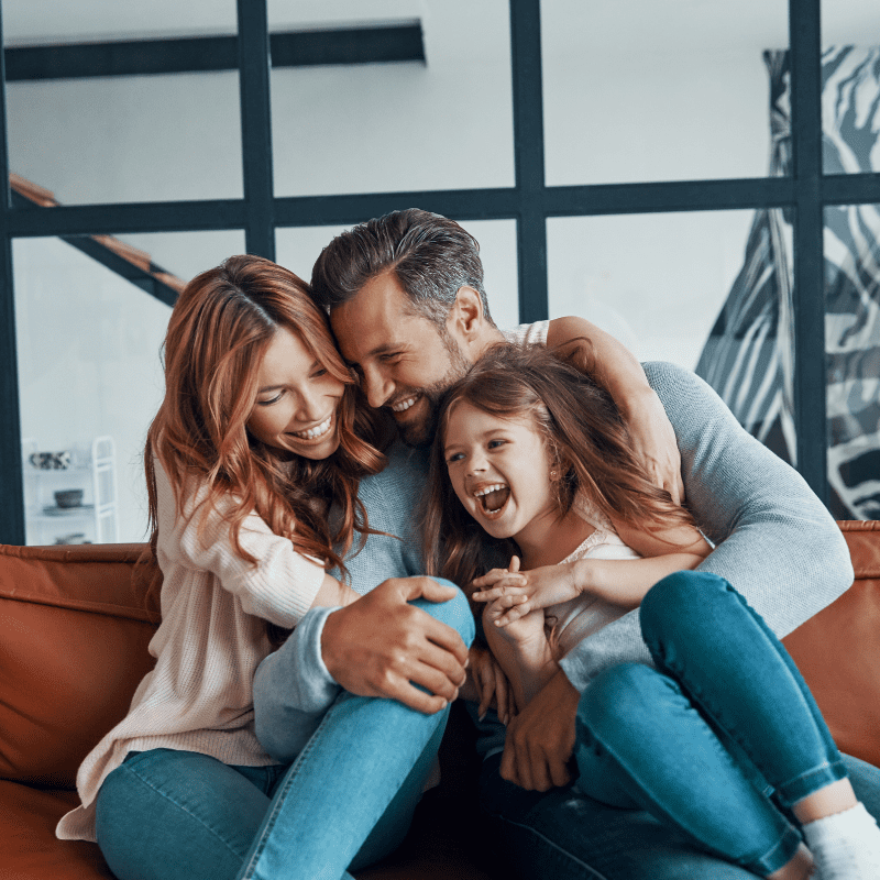 Happy family of three at home. See how you can protect your home and belongings with Monarch and get the peace of mind you deserve. 